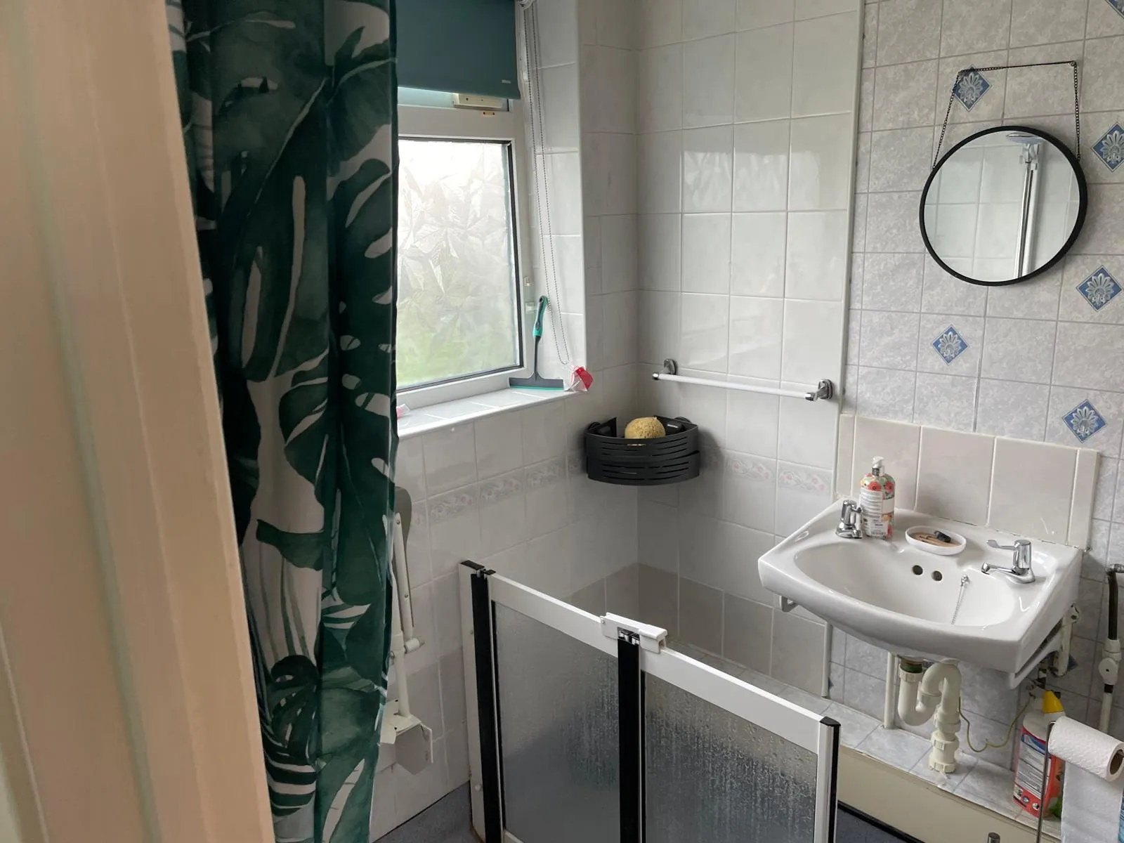 The old bathroom with a shower curtain, before the refit